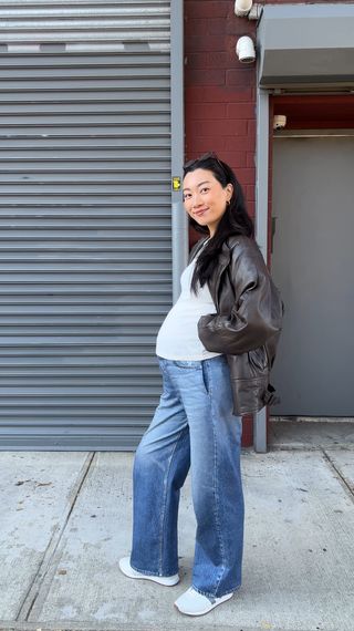 Yuri Mori wearing a t-shirt, a leather jacket, and jeans