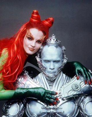 Arnold Schwarzenegger and Uma Thurman as poison ivy and mr. freeze posing together in elaborate costumes for Batman and Robin