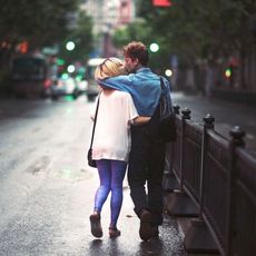 Man and woman walking and kissing