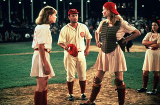 tom hanks and geena davis stand on the pitcher's mound in a league of their own