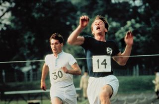 two men race for the finish line with number 14 nearly crossing it in chariots of fire