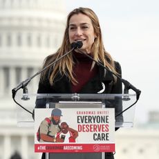 Dawn Huckelbridge, Director of Paid Leave for All, speaks at a rally for the "Build Back Better" plan in December 2021.