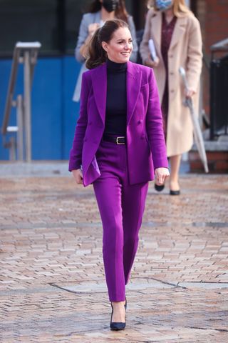 Kate Middleton walking in a purple suit and high heels