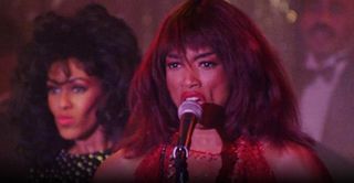 Angela Bassett sings into a microphone as Tina Turner in the movie what's love got to do with it