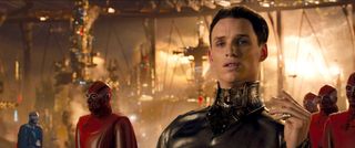 eddie redmayne wears a silver suit as an outerspace war unfolds around him in the movie Jupiter ascending