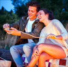 couple making smores at bonfire, a cheap date idea