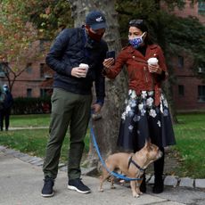 2d7w3f0 congresswoman alexandria ocasio cortez r stands in line with her partner riley roberts and her french bulldog named deco as she waits to vote early at a polling station in the bronx, new york city, us, october 25, 2020 reutersandrew kelly