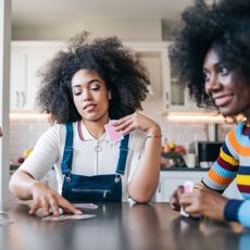 Three girls playing cards