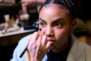 A woman receiving non comedogenic makeup application to her skin