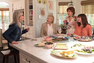 a group of older women standing around a kitchen island in the movie book club