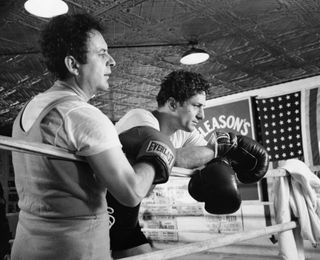 robert de niro stands over a boxing ring in raging bull