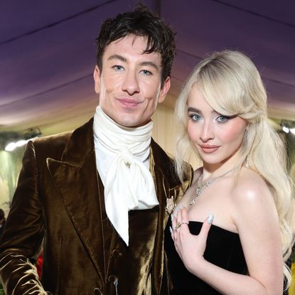 Sabrina Carpenter wearing a strapless dress posing with Barry Keoghan in a white ruffled shirt and velvet jacket at the Met Gala