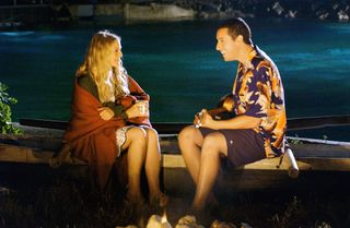 drew barrymore and adam sandler sitting on the beach in 50 First Dates