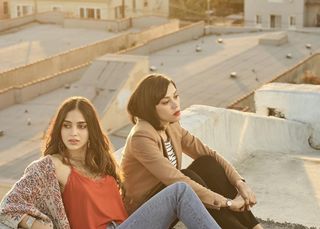 two women sit on a rooftop in the show Vida