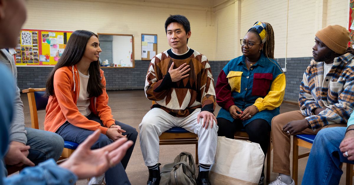 Group of people sat in a circle and engaged in a discussion