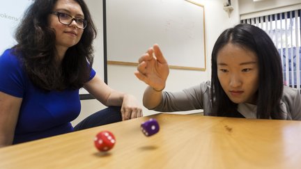 Marina Agranov with student rolling dice