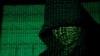 FILE - Binary code is projected onto a hooded man in this illustration photo taken on May 13, 2017. (TPX Images via Reuters)