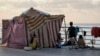 A displaced family, fleeing the Israeli airstrikes in the south, sits next to their tent on Beirut's corniche, Lebanon, Oct. 14, 2024.