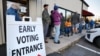 Voters wait to cast their ballot on the first day of early in-person voting in one of the mountainous regions badly affected by Hurricane Helene, in Marion, North Carolina, Oct. 17, 2024.