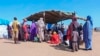 FILE - Sudanese refugees gather outside a field hospital in Acre, Chad, Aug. 15, 2023. 