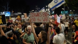 A demonstrator holds a sign about the killing of Hamas leader Yahya Sinwar during a protest calling for a cease-fire deal and the immediate release of hostages held by Hamas on Oct. 17, 2024, in Tel Aviv, Israel.