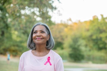 beautiful senior woman smiles while walking for breast cancer awareness