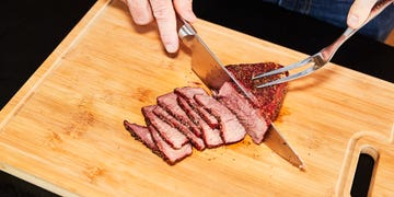 a person cutting meat with a knife