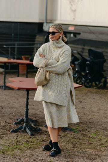 a person wearing a cashmere sweater and sunglasses