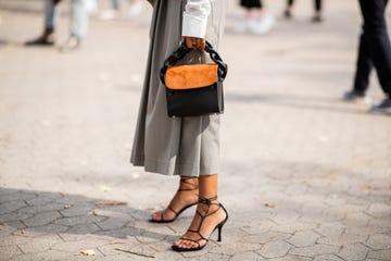 a woman at copenhagen fashion week wears strappy sandals to illustrate a guide to the best summer sandals 2024