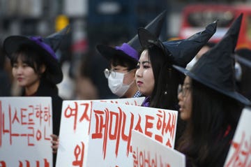 topshot south korean women dressed as witch hold placards supporting feminism during a protest to mark international womens day in seoul on march 8, 2019 photo by jung yeon je afp photo by jung yeon jeafp via getty images