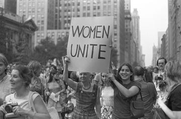 womens strike for equality a protest organized by the national organization for women, march in celebration of the fiftieth anniversary of the 19th amendment, for abortion on demand, equality in the workplace and free childcare an older and young woman hold up a sign women unite as they march down fifth avenue in new york city, new york photo by bob parentgetty images