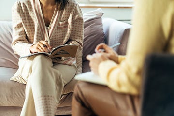 two women in armchairs are sitting and talking woman psychologist practicing with patient women coach session between girlfriends therapists gestures female talking in the office