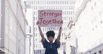 street, protest and cardboard of black woman sign for solidarity, gender equality and power in government, politics and law revolution, justice and city student with poster portrait for human rights