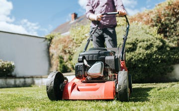 man pushing lawn mower