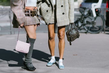 two women wearing miu miu flats and mini skirts to illustrate a guide to the best comfortable flats women 2024