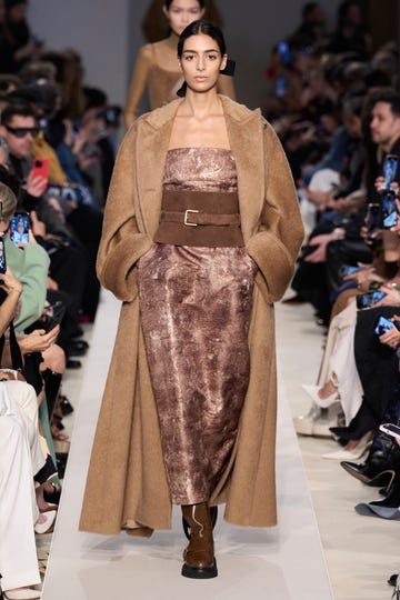 a max mara model wears a warm winter coat in teddy fabric from max mara with a corset belt