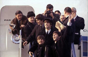 group of people exiting an airplane at an airport