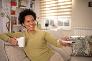 woman enjoying her favorite tv show at home