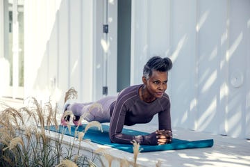 woman in plank position on exercise mat