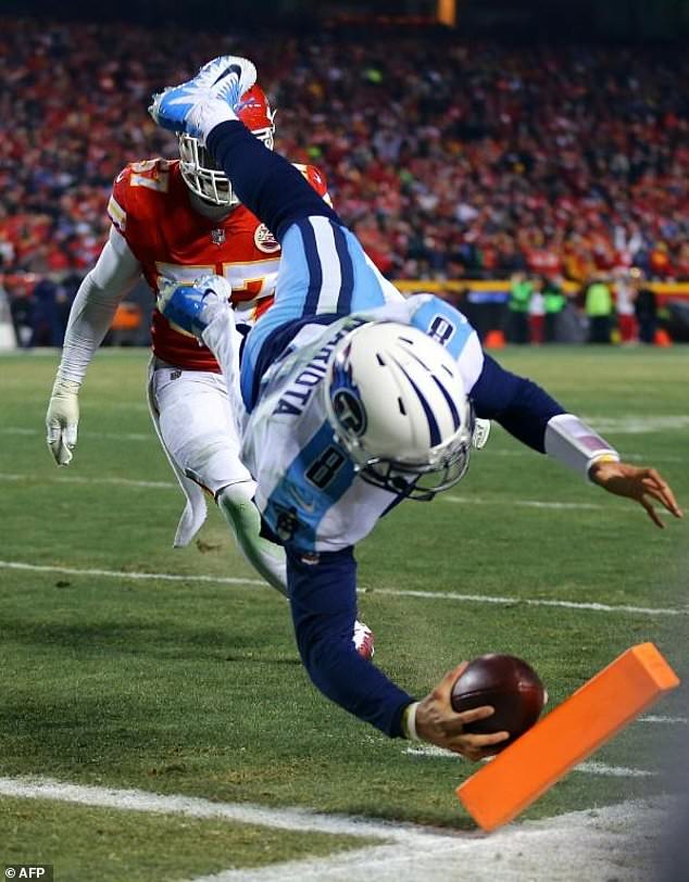 Quarterback Marcus Mariota of the Tennessee Titans scores a touchdown on a pass from himself during the AFC Wild Card playoff game against the Kansas City Chiefs