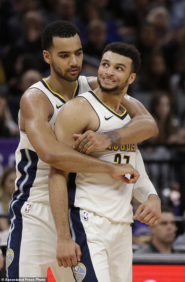 Denver Nuggets guard Jamal Murray is held by teammate Trey Lyles, after Murray was called for a foul during the second half of the team's NBA basketball game against the Sacramento Kings on Saturday, Jan. 6, 2018, in Sacramento, Calif. The Kings won 106-98. (AP Photo/Rich Pedroncelli)