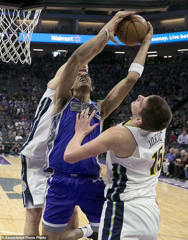 Sacramento Kings forward Skal Labissiere, center, goes to the basket between Denver Nuggets' Mason Plumlee, left, and Nikola Jokic during the second half of an NBA basketball game Saturday, Jan. 6, 2018, in Sacramento, Calif. The Kings 106-98. (AP Photo/Rich Pedroncelli)