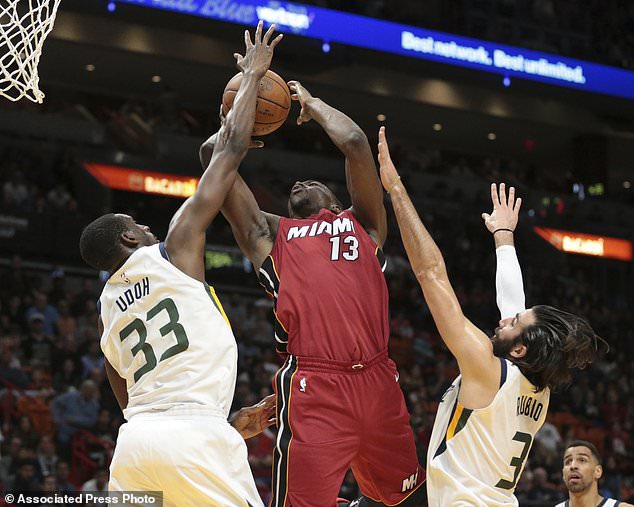 Miami Heat center Bam Adebayo (13) goes to the basket between Utah Jazz guard Ricky Rubio (3) and center Ekpe Udoh (33) during the first half of an NBA basketball game, Sunday, Jan. 7, 2018, in Miami. (AP Photo/Joel Auerbach)