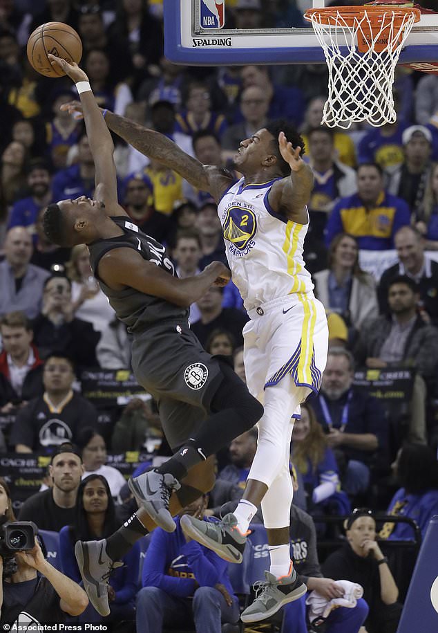 Golden State Warriors forward Jordan Bell, right, defends a shot by Brooklyn Nets guard Caris LeVert during the first half of an NBA basketball game in Oakland, Calif., Tuesday, March 6, 2018. (AP Photo/Jeff Chiu)