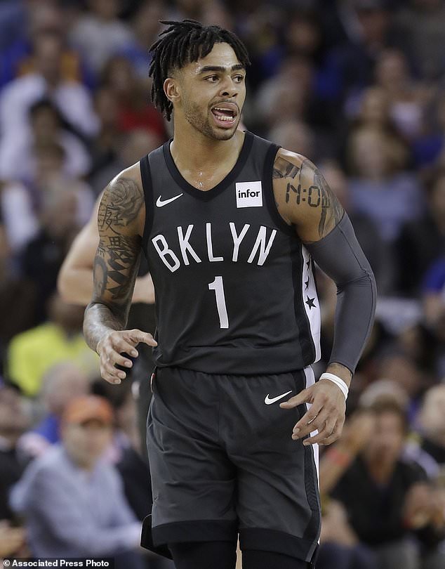 Brooklyn Nets guard D'Angelo Russell runs up the court after scoring against the Golden State Warriors during the first half of an NBA basketball game in Oakland, Calif., Tuesday, March 6, 2018. (AP Photo/Jeff Chiu)