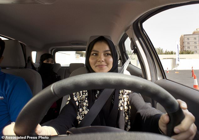 A student at the female-only campus of Effat University, sits for the first time in the driver's seat, during training sponsored by Ford Motor, in Jiddah, Saudi Arabia, Tuesday, March 6, 2018. A stunning royal decree issued last year by King Salman announcing that women would be allowed to drive in 2018 upended one of the most visible forms of discrimination against women in Saudi Arabia. (AP Photo/Amr Nabil)