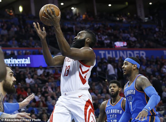 Houston Rockets guard James Harden (13) goes up for a shot between Oklahoma City Thunder center Steven Adams, left, forward Paul George (13) and forward Carmelo Anthony (7) in the first half of an NBA basketball game in Oklahoma City, Tuesday, March 6, 2018. (AP Photo/Sue Ogrocki)