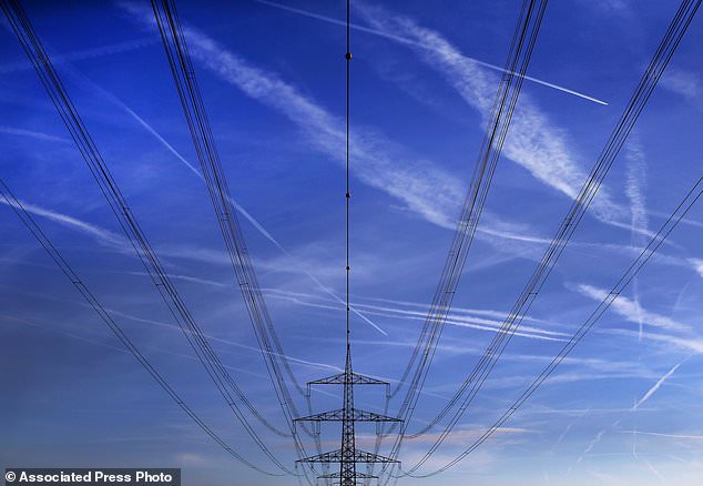 FILE - In this Nov. 1, 2017 file photo high power cables hang from a pole on a field in Hattersheim, Germany. Millions of Europeans who arrived late to work or school Wednesday March 7, 2018 have a good excuse: an unprecedented slowing of the frequency of the continent's electricity grid. The Brussels-based European Network of Transmission System Operators for Electricity, or ENTSO-E, says the problem began mid-January and affects 25 countries, from Portugal to Poland and Greece and Germany.  (AP Photo/Michael Probst,file)