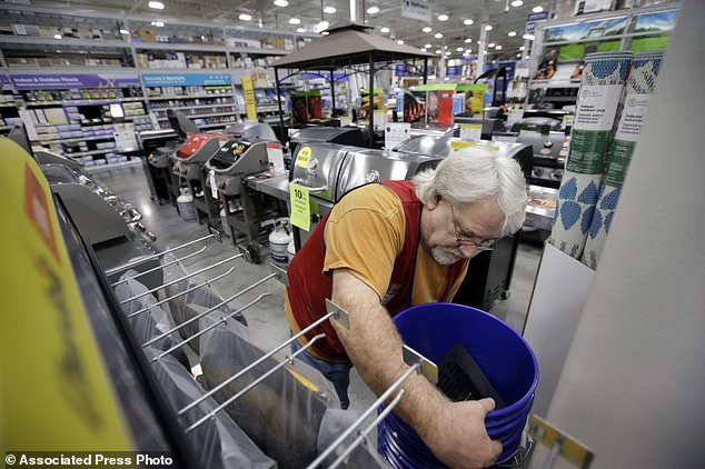 FILE- In this Feb. 23, 2018, file photo sales associate Bob Henriques, of Framingham, Mass., moves items at a Lowe's retail home improvement and appliance store, in Framingham. Lowe's Companies Inc. reports earnings on Wednesday, May 23. (AP Photo/Steven Senne, File)