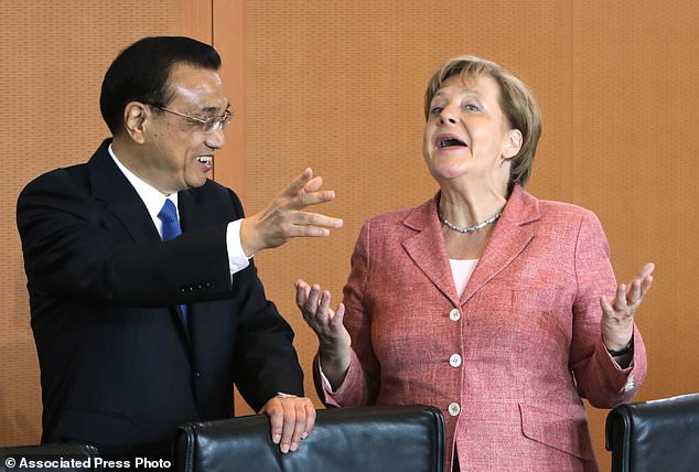 FILE - In this May 31, 2017 file photo German Chancellor Angela Merkel and China's Premier Li Keqiang joke prior to a meeting at the chancellery in Berlin, Germany.     German Chancellor Angela Merkel is heading to China with a business delegation on Wednesday afternoon.  (AP Photo/Ferdinand Ostrop, pool, file)